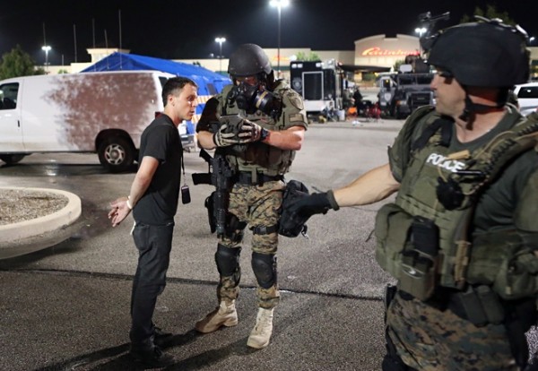 The author, detained by a St. Louis County Police Department tactical team Tuesday morning, explains to an officer how to turn off his digital recorder. Photo: David Carson/St Louis Post Dispatch/Polaris