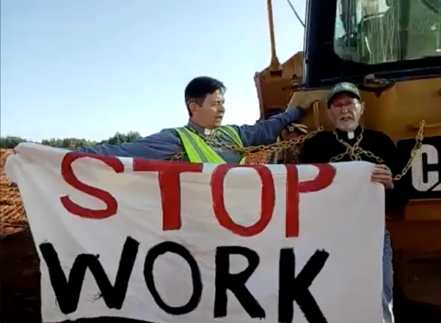 Defying RICO Indictment, Faith Leaders Chain Themselves to Bulldozer to Stop Cop City