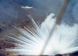 A U.S. Air Force Douglas A-1E Skyraider drops a white phosphorus bomb on a Viet Cong position in South Vietnam in 1966